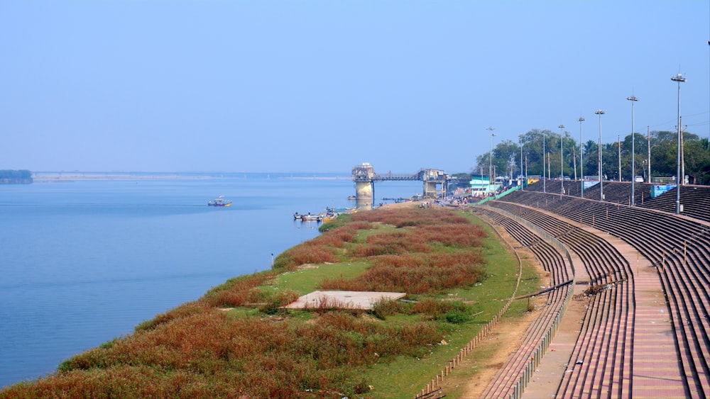 a train track next to a body of water