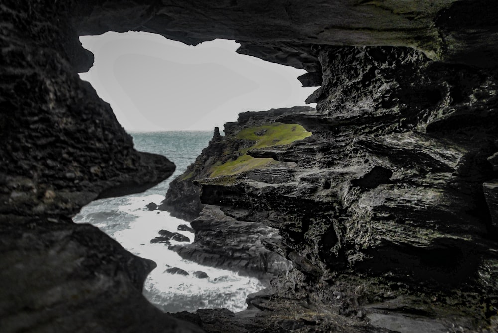 a view of a body of water through a cave