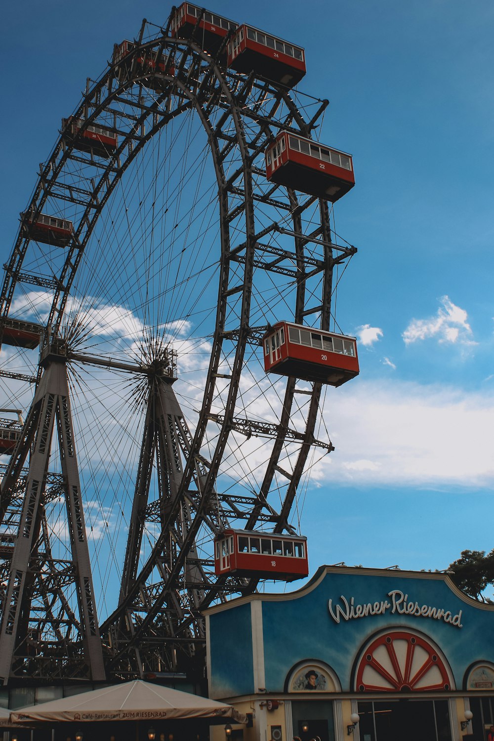 a large ferris wheel sitting next to a building