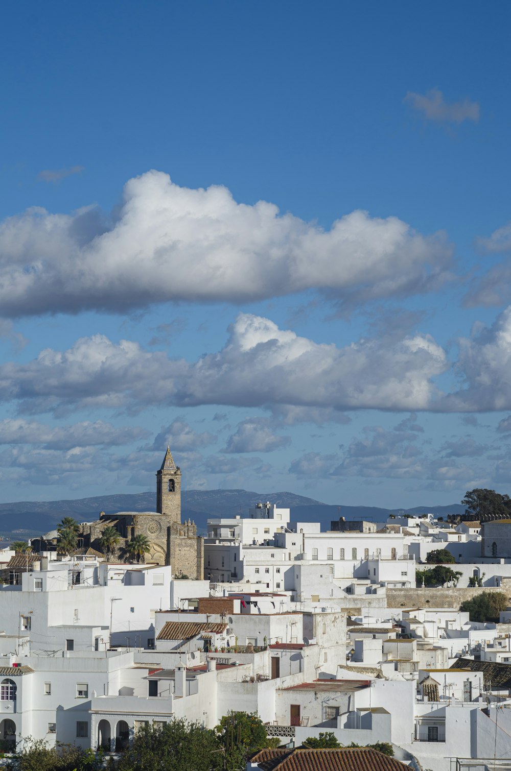 a city with white buildings and a clock tower