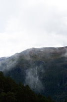 a mountain with a waterfall in the middle of it