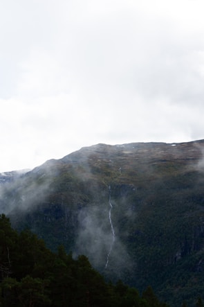 a mountain with a waterfall in the middle of it