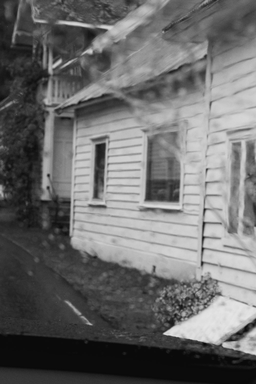 a black and white photo of an old house