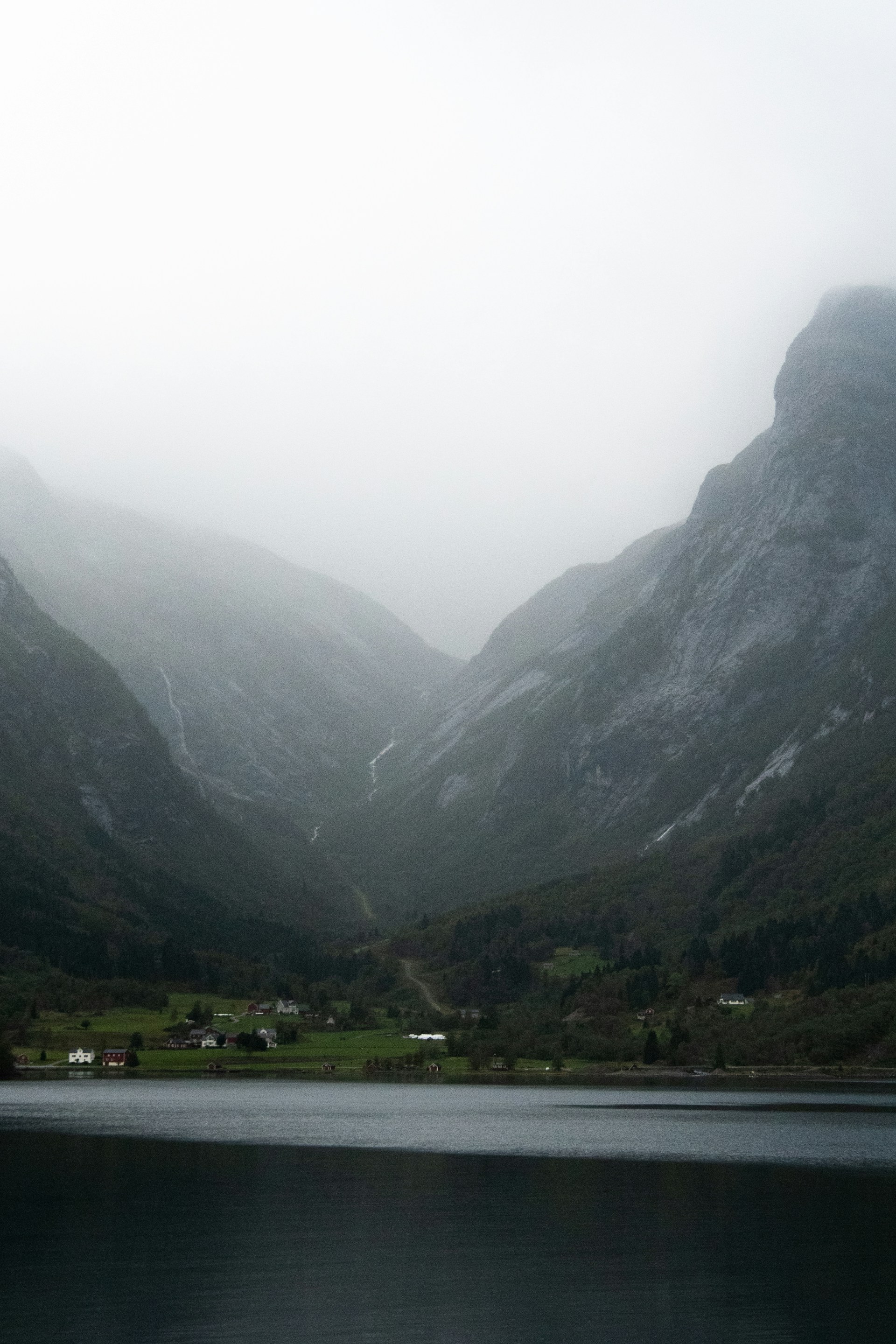 a body of water with mountains in the background