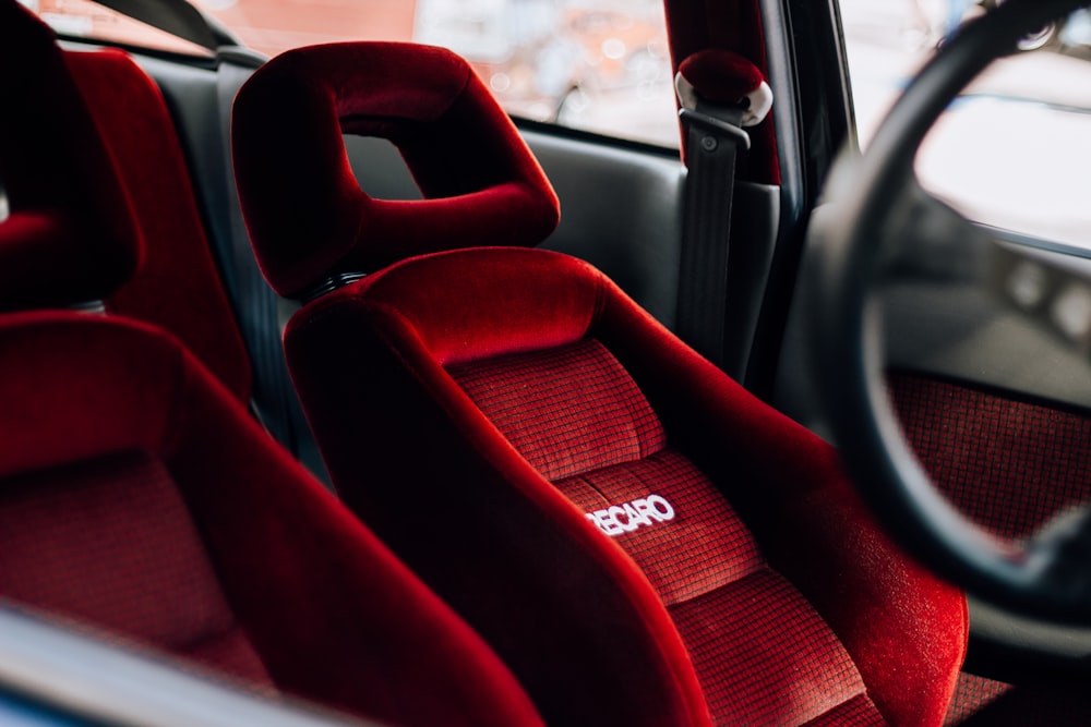 the interior of a car with red seats