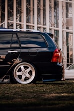a black car parked in front of a building