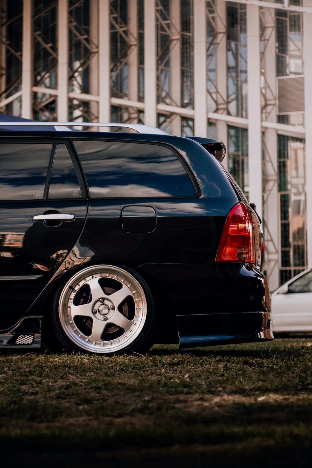 a black car parked in front of a building