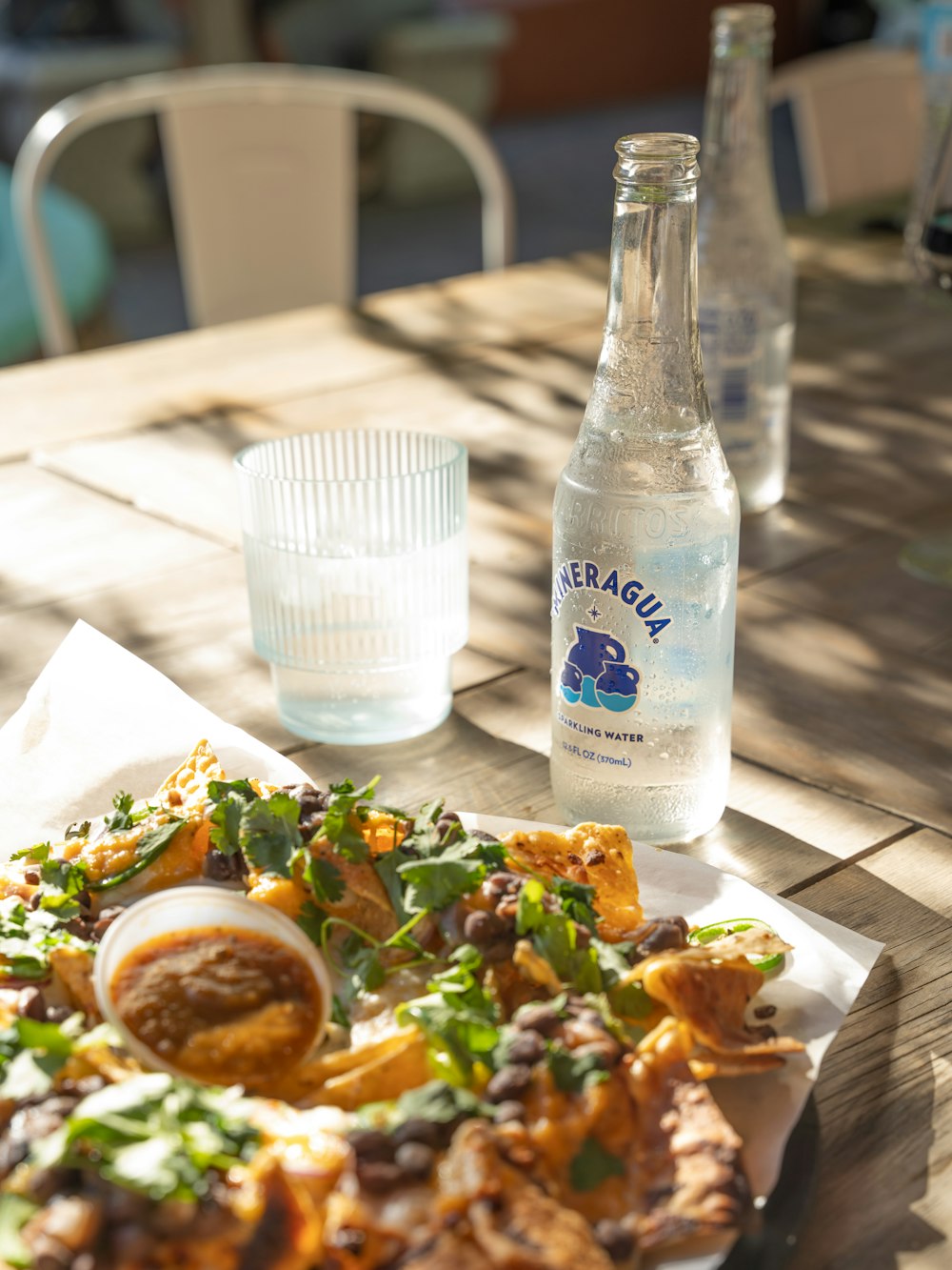 a plate of food and a bottle of water on a table