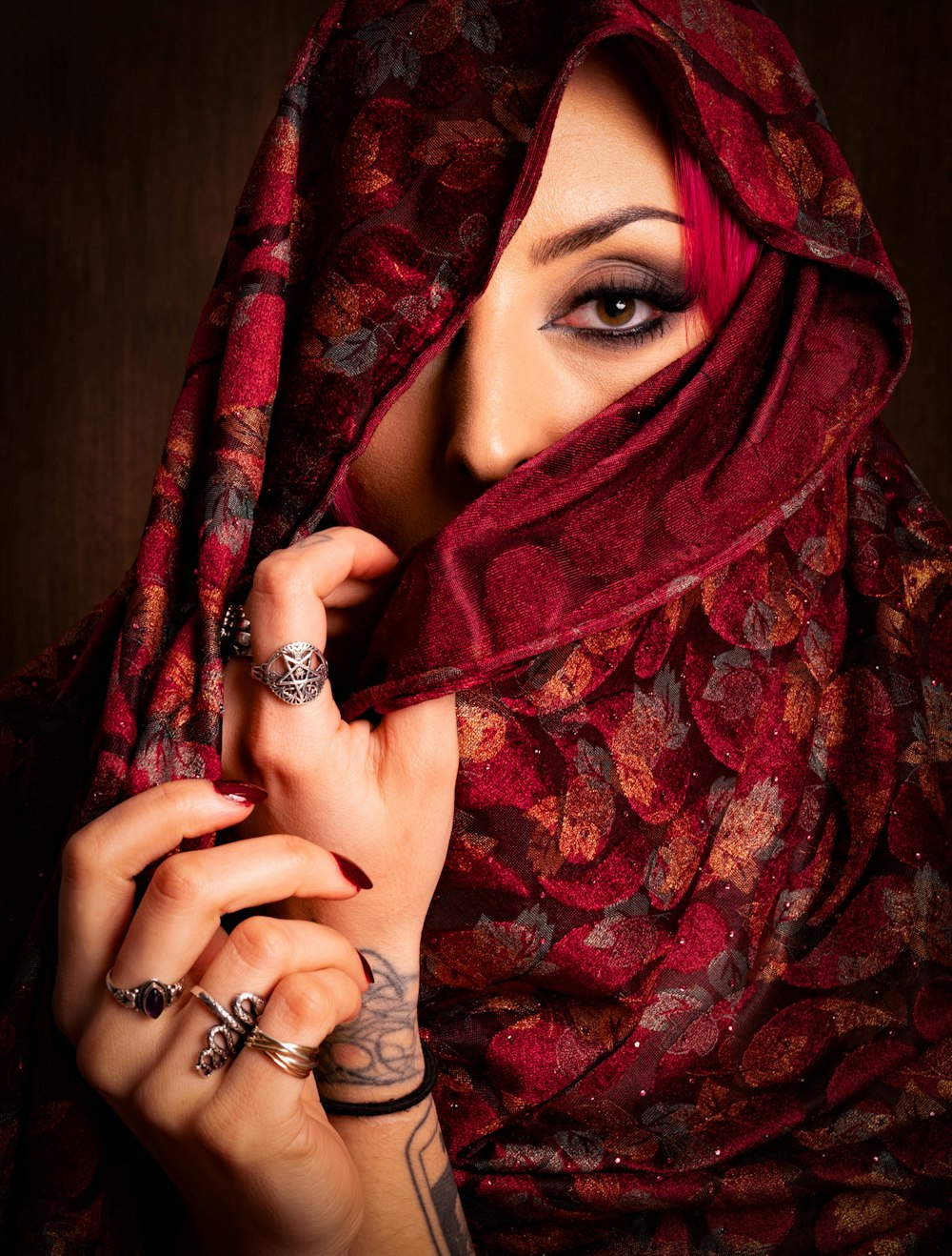 a woman wearing a red scarf and rings