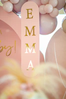 A set of colorful 3D printed letters spelling 'EMMA' with alternating green and yellow hues.