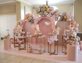 a pink and gold birthday party with balloons