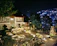 Close-up of a beautifully crafted stone patio with clean lines and elegant lighting at dusk.