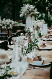 a long table with plates and vases on it