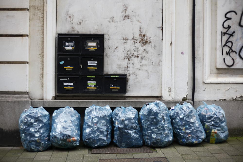 a bunch of bags sitting on the side of a building