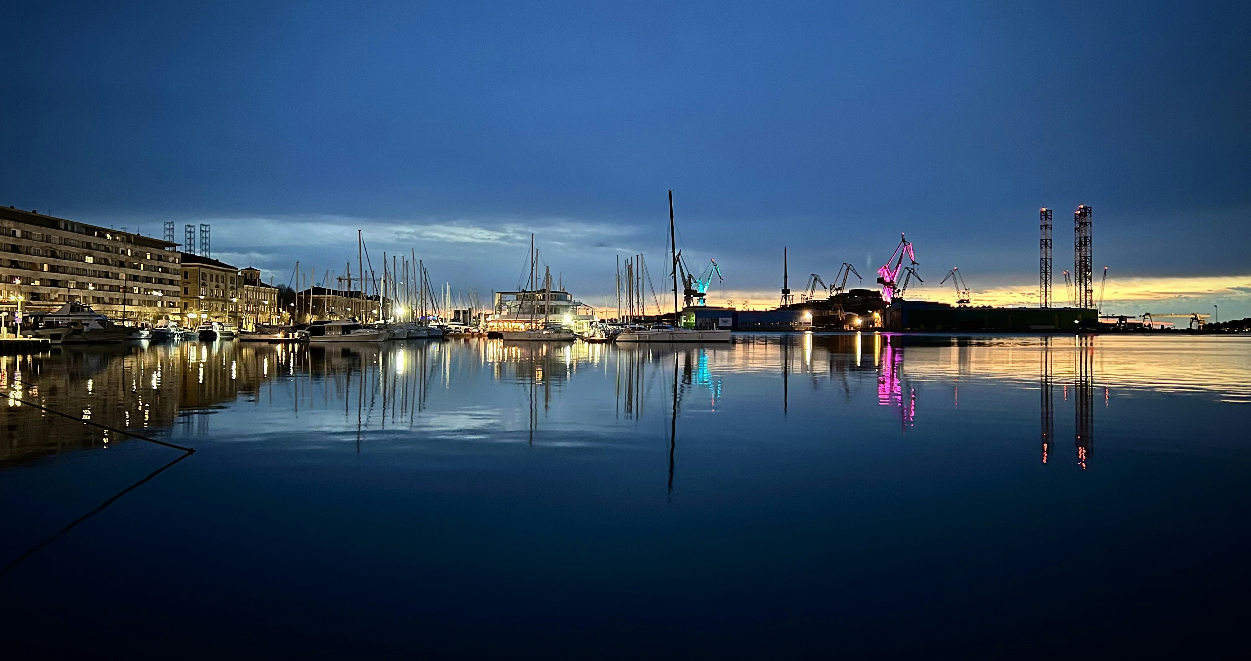 a harbor filled with lots of boats at night