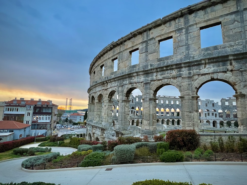 a large stone building with arched windows on top of it