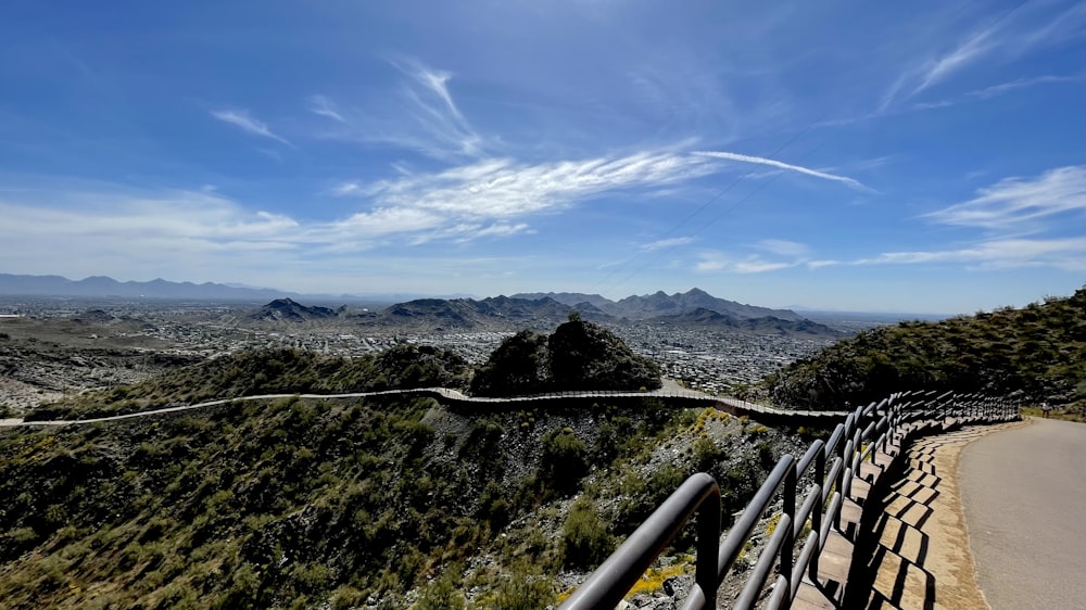 a view of a winding road with mountains in the background