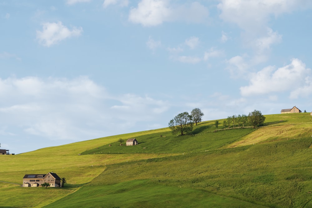 a grassy hill with a house on top of it