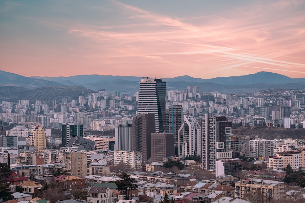 a view of a city with mountains in the background