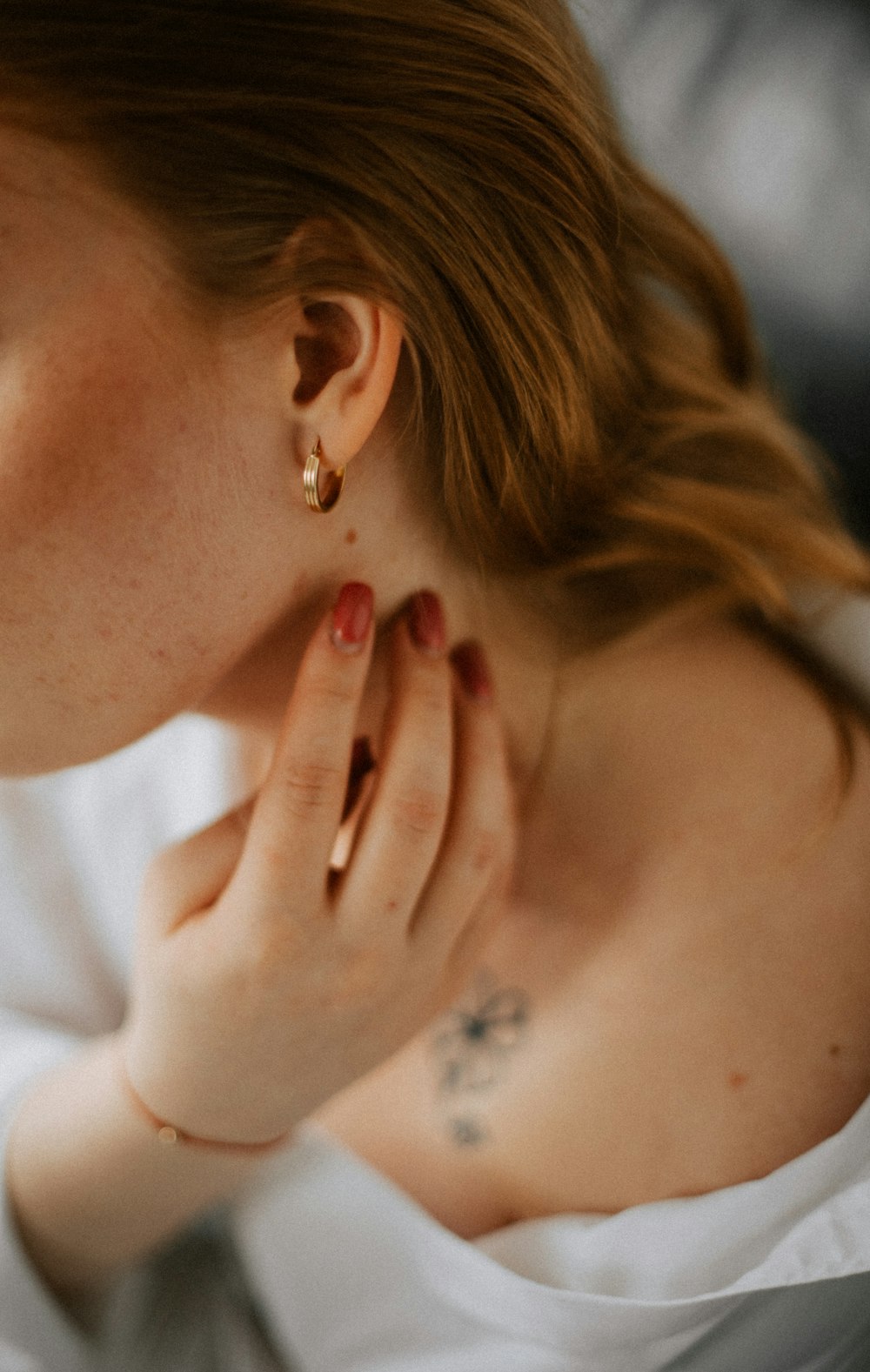 a close up of a person wearing a white shirt