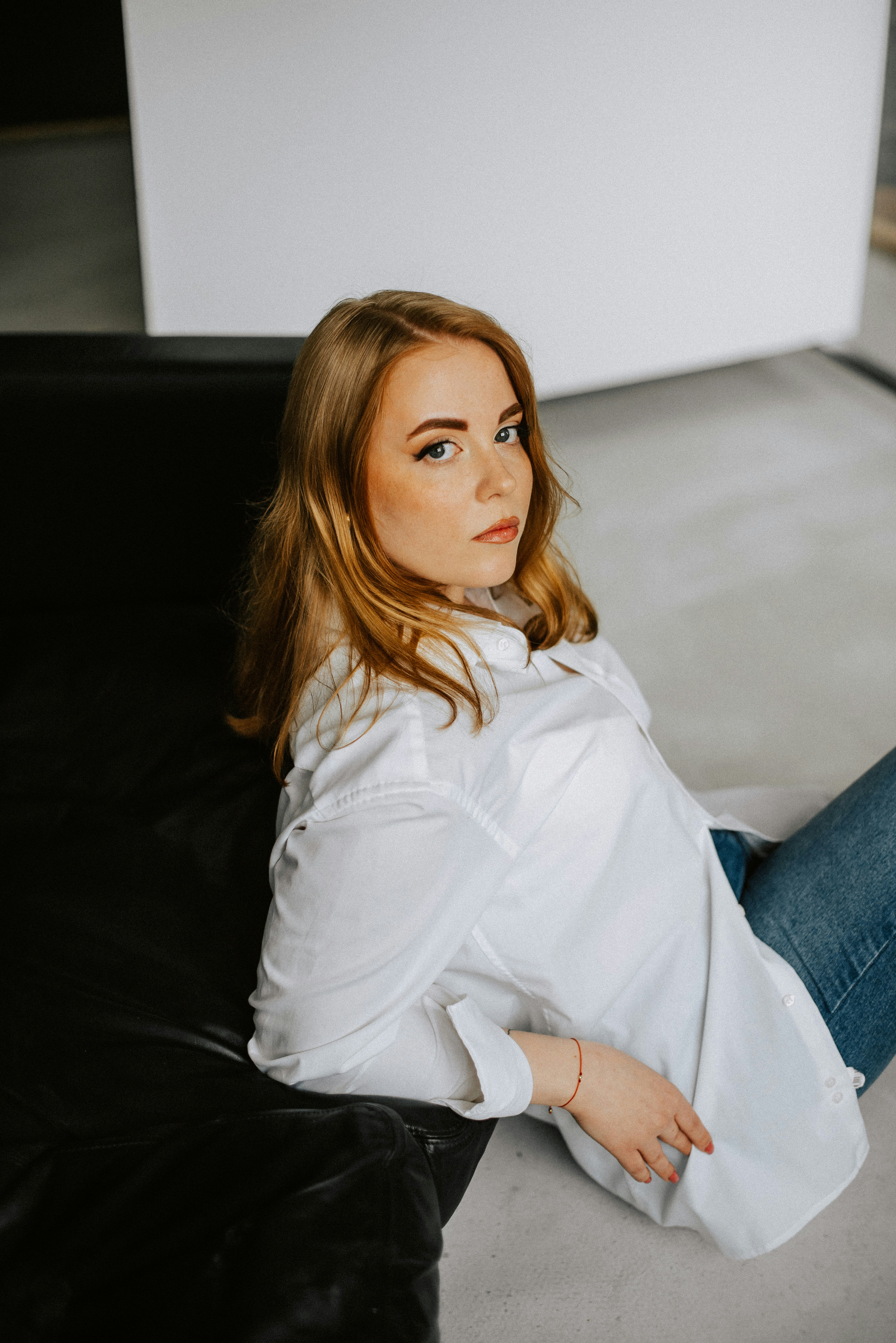 a woman sitting on a couch with her legs crossed