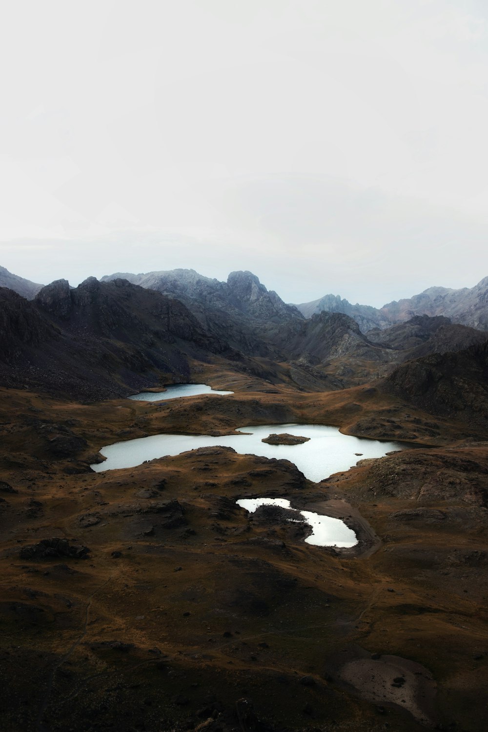 a view of a mountain range with a lake in the foreground