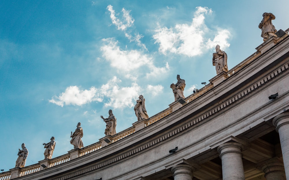 a group of statues on top of a building