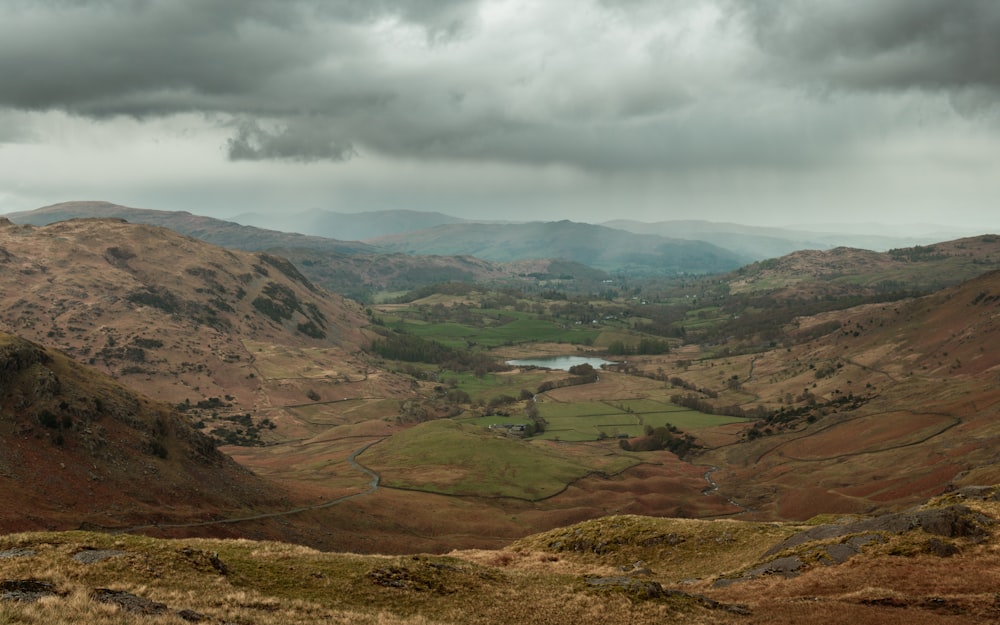 a view of a valley with a lake in the middle