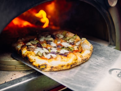a pizza is being cooked in an oven