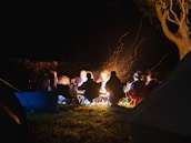 A group of travelers sharing stories around a campfire.