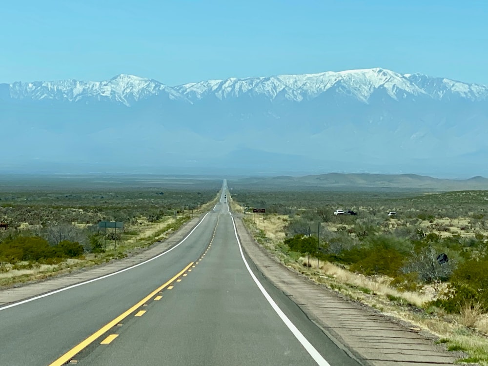 a highway with a mountain range in the background