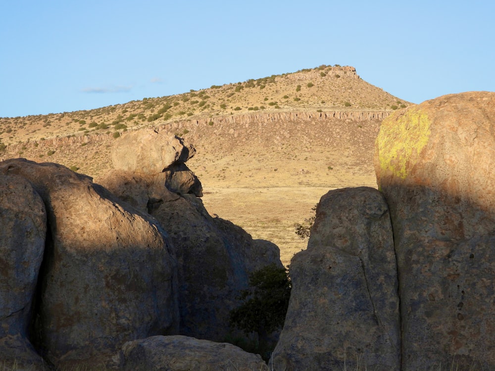 a large rock formation in the middle of a desert