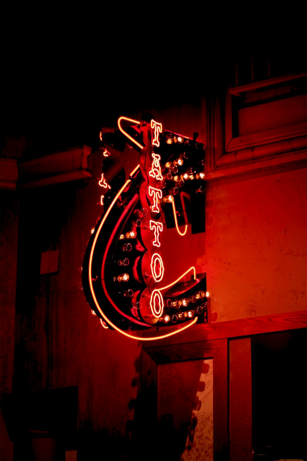 a neon sign that is on the side of a building