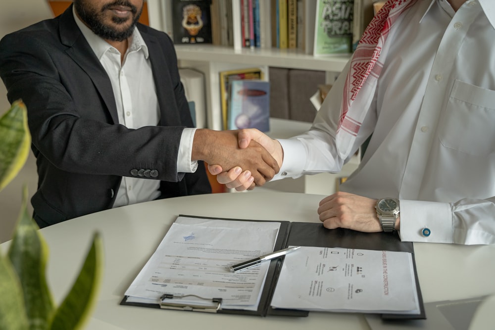 A candidate and recruiter shaking hands after closing a tech offer