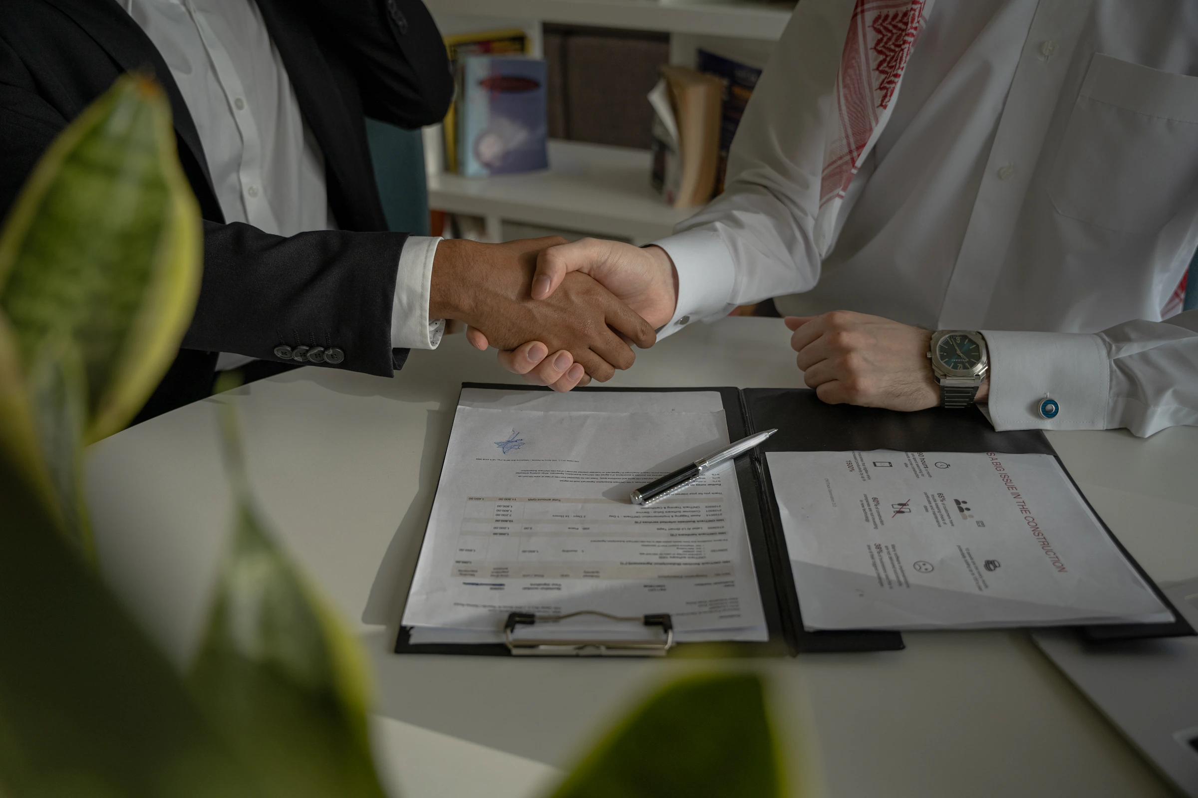Handshake over a desk during a home financing meeting