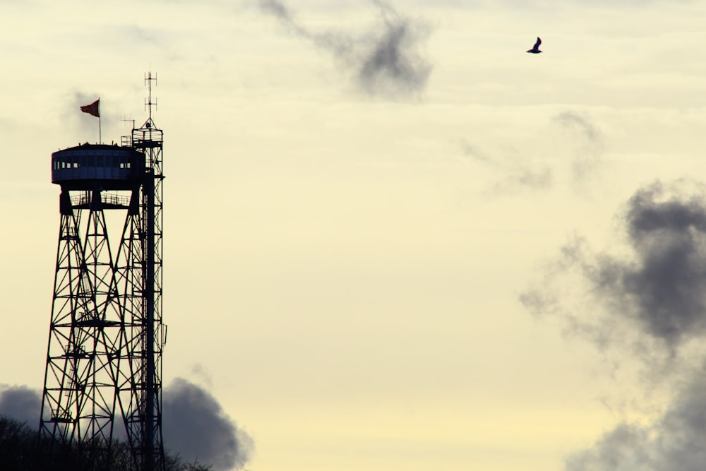 a tall tower with a flag on top of it