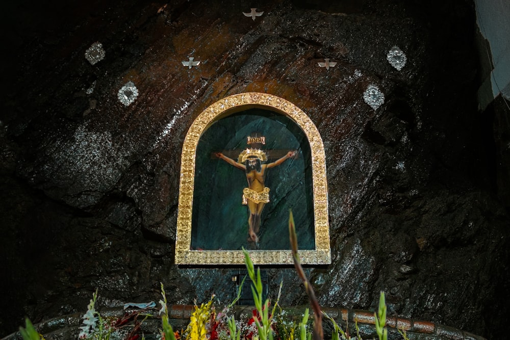 a painting of a crucifix in a cave