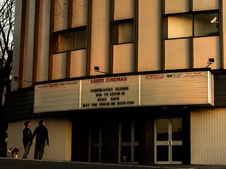 a couple of people that are standing in front of a building
