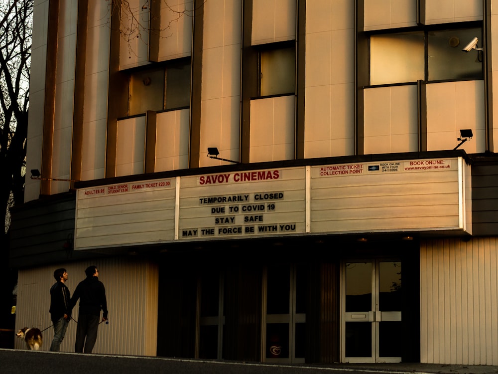 a couple of people that are standing in front of a building