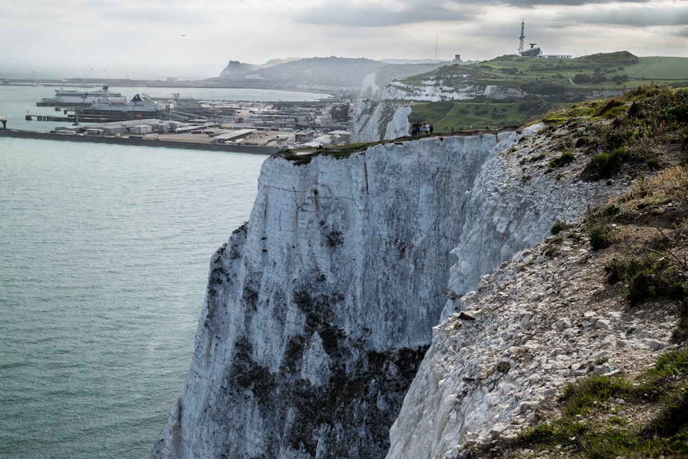 a view of a large body of water next to a cliff