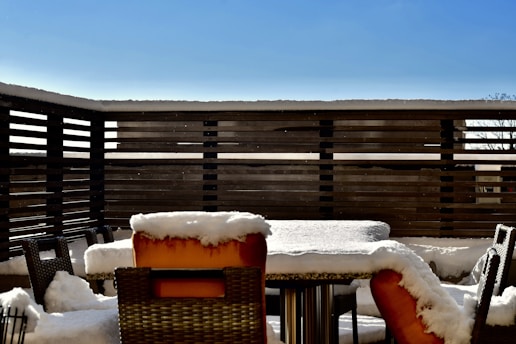 A sparkling clean patio with neatly arranged outdoor furniture after pressure washing.