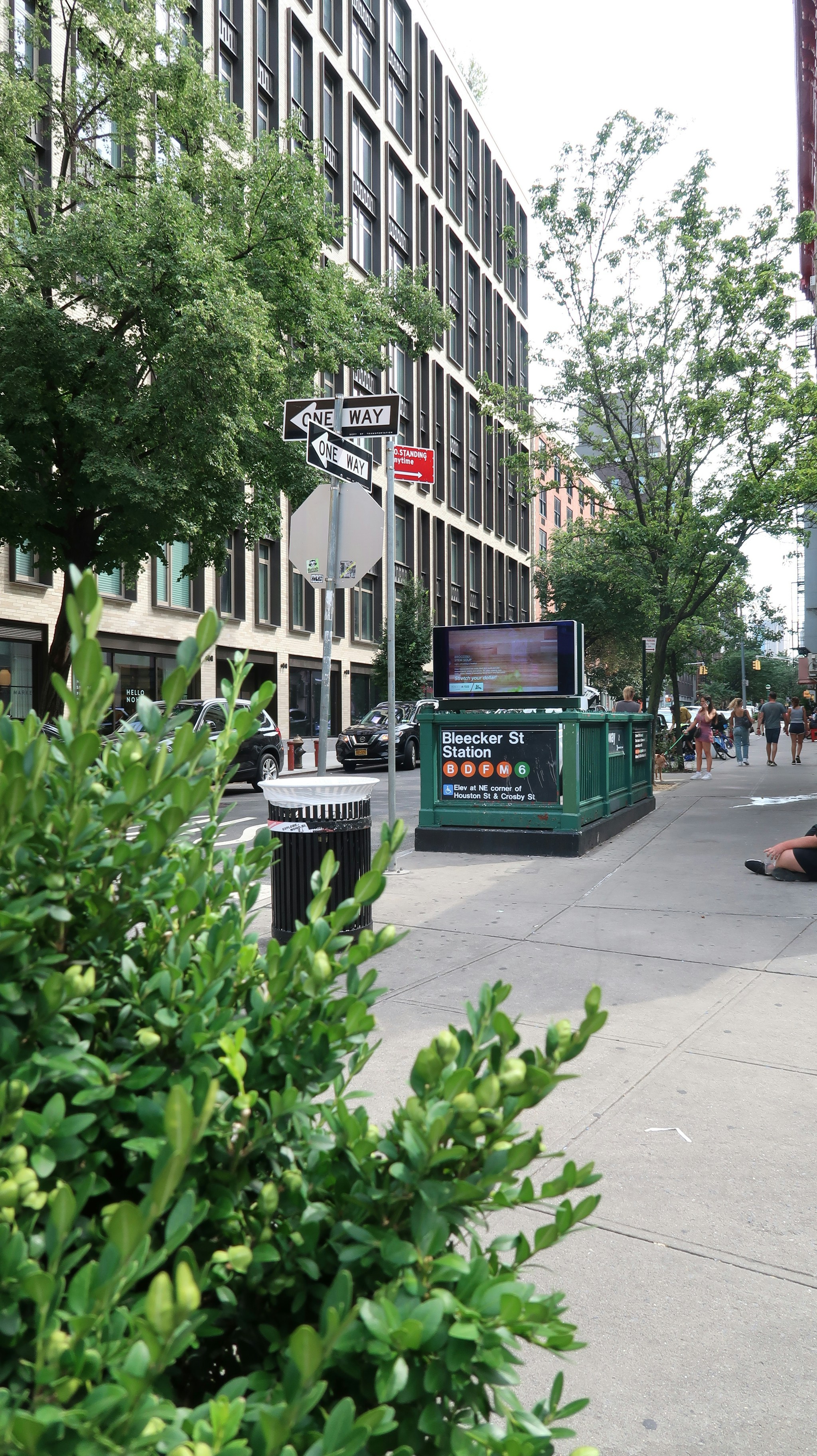 a city street with people walking on the sidewalk