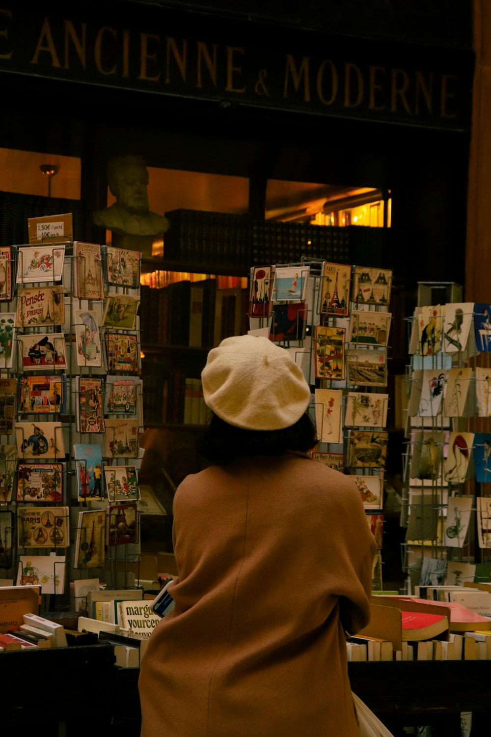 a woman sitting on a bench in front of a store