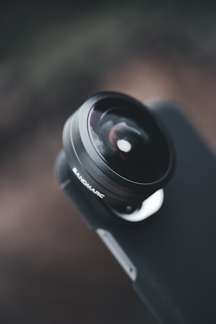 Close-up of a camera lens focusing on a vibrant product display for a startup brand.