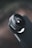 A close-up view of a camera lens affixed to a smartphone. The focus on the lens is sharp while the background is blurred, creating a depth of field effect. The brand 'SANDMARC' is visible on the lens mount. The overall composition highlights the sleek and modern design of the accessory.