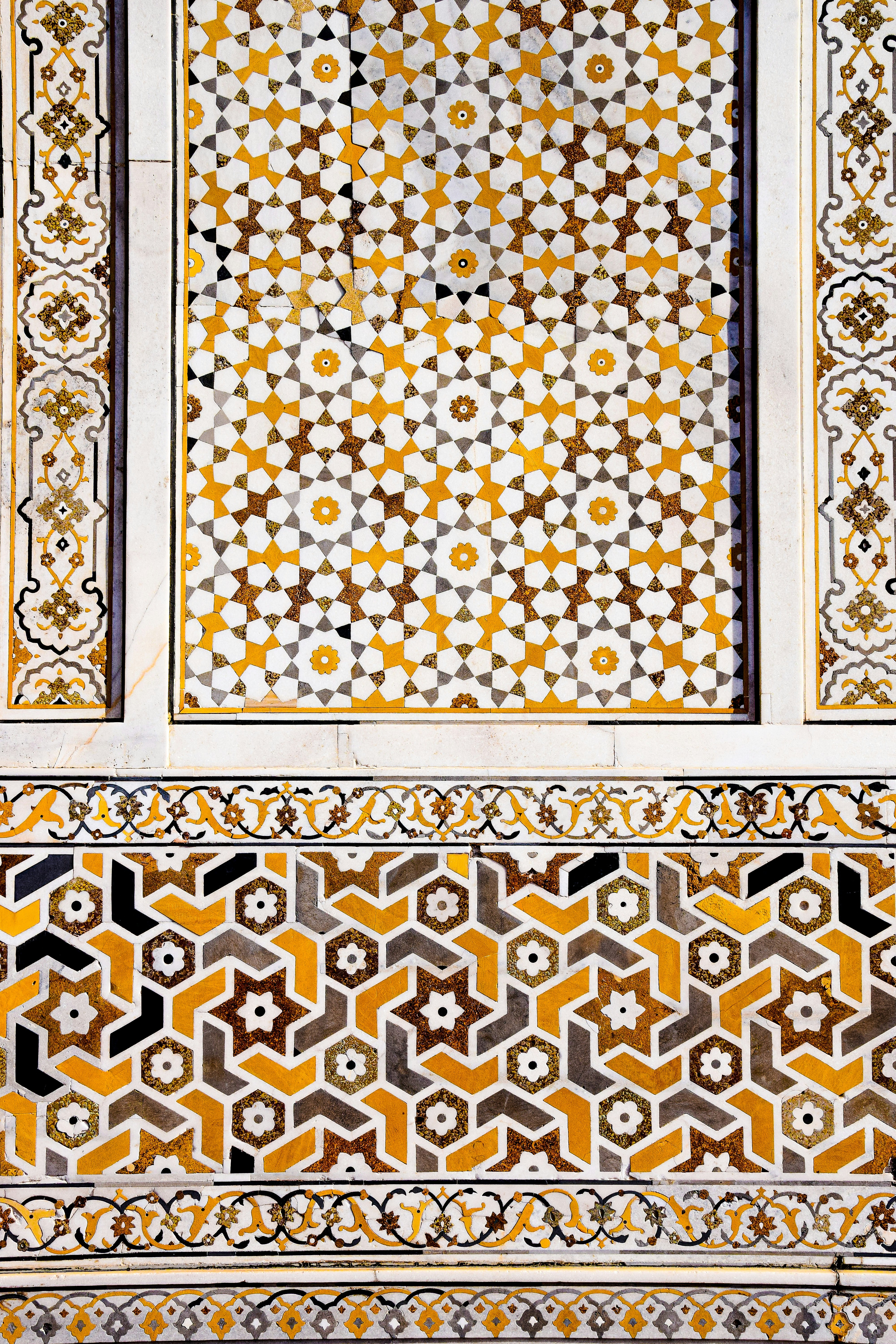 A wall with a pattern on it in the middle of a building photo – Free ...