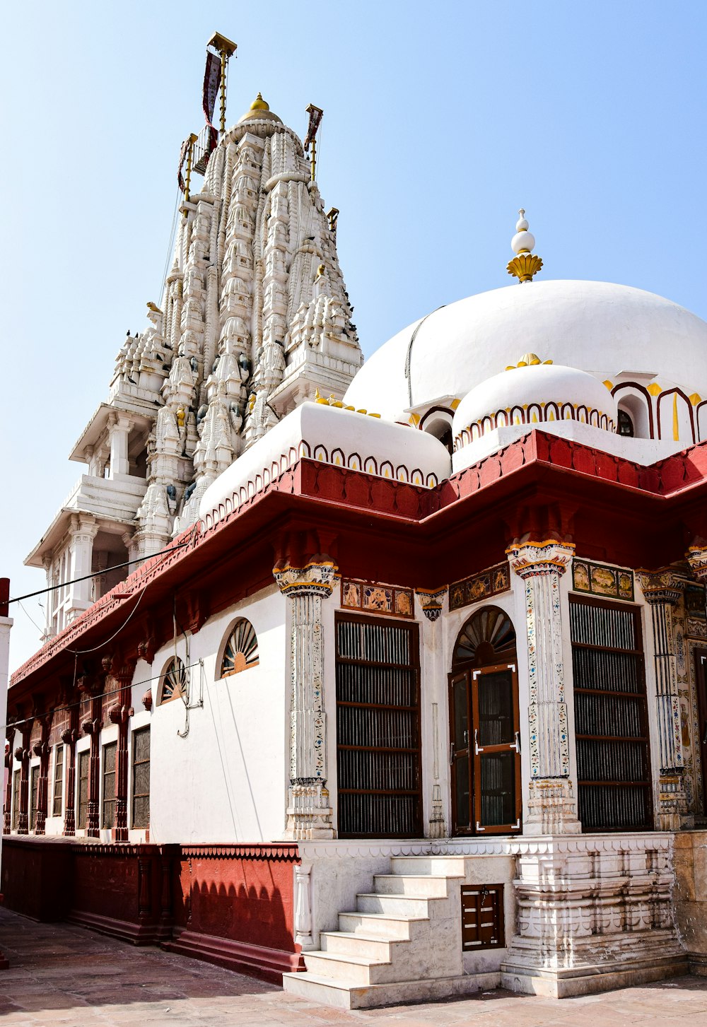 a white and red building with a white dome