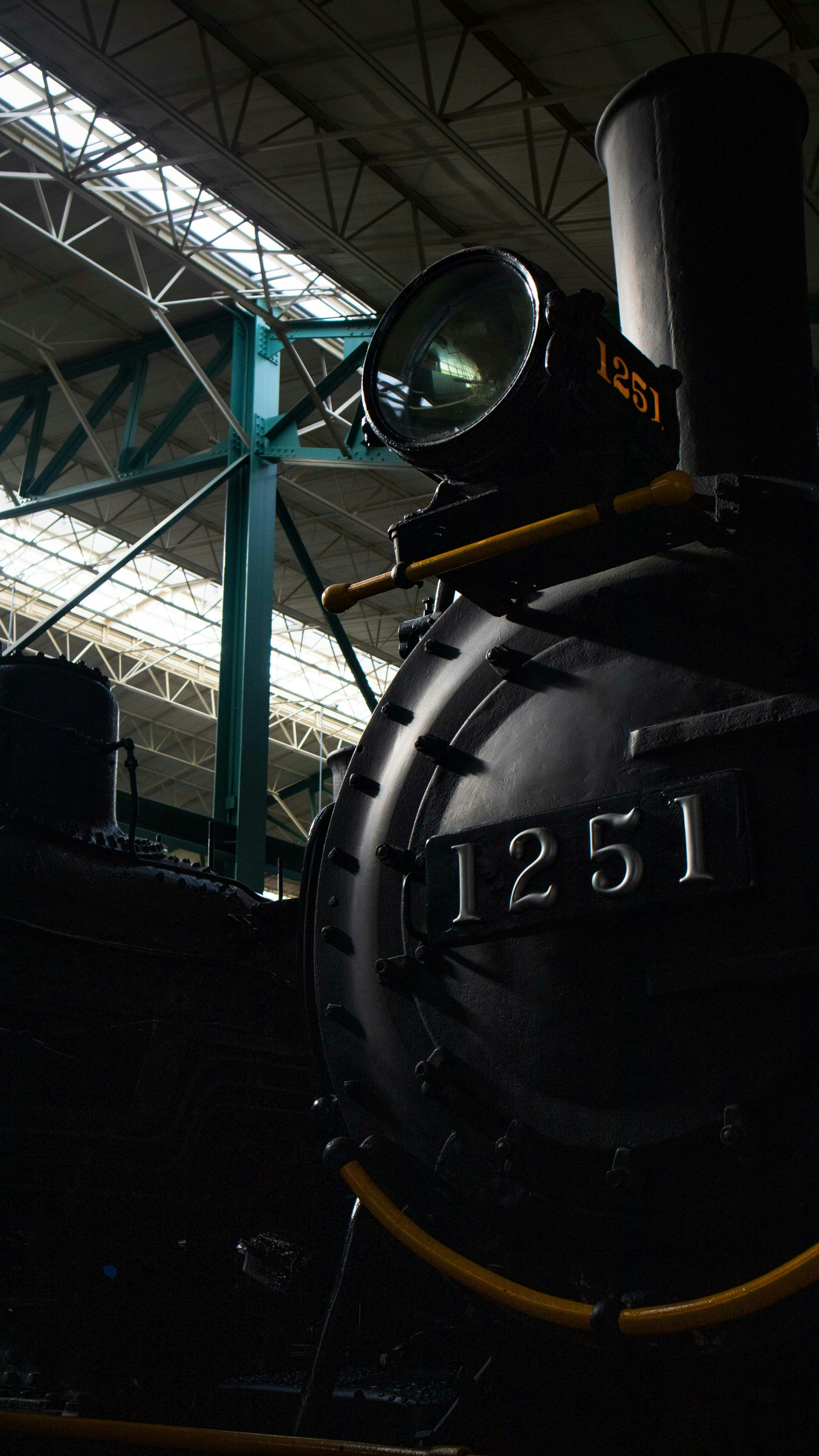 a black train sitting inside of a train station