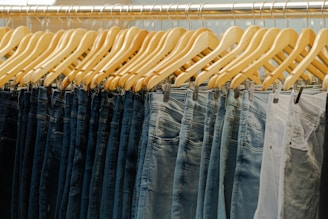 a row of jeans hanging on a rack