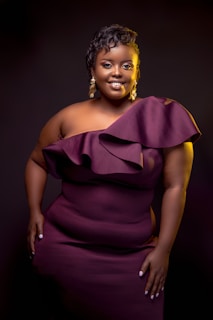a woman in a purple dress posing for a picture